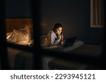A little late night research. Cropped shot of an attractive young woman studying late at night in her bedroom at home.