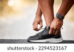 Small photo of A increasing lack of fitness, is a menace to health. Shot of a unrecognizable man tying his shoelaces outside.