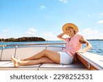 Time to get away. a mature woman enjoying a relaxing boat ride.