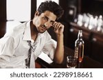 Small photo of Business man, drinking and portrait in happy hour at a bar with alcohol and whiskey after work. Bottle, male person and face in a restaurant with a playboy guy and a glass and confidence in pub