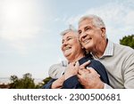 Small photo of Sky, elderly couple and hug outdoors or happy in retirement or husband and wife in nature. Mature, man and woman smile in vacation or senior citizens care and embrace or date at the park for romance