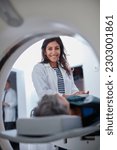 Small photo of Doctor, mri and portrait of woman with patient to comfort in hospital for machine scanning. Ct scan, holding hands or smile of medical professional with senior person in radiology test for healthcare