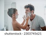 Small photo of Child, father and learning to shave, smile and bonding together in home bathroom. Happy, dad and teaching kid with shaving cream on face beard, playing or cleaning, hygiene or enjoying hair removal.