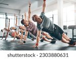 Small photo of Gym class, group and athletes doing a workout for fitness, health or wellness flexibility. Sports, community and people doing a side plank exercise, training or challenge together in a sport studio.