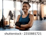 Happy black woman, portrait smile and fitness with arms crossed for workout, exercise or training at the gym. Fit, active or sporty African female person or athlete smiling for healthy wellness