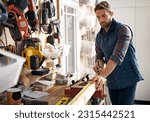 Man, wood and tape measure for construction, home development and building renovation. Carpenter, maintenance employee and male repairman worker on a contractor job of builder working in house