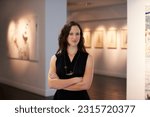 Small photo of Expert, arms crossed and portrait of a woman at an art gallery for an exhibition. Creative, culture and a museum manager with management of paintings, collection and curator of pictures at a studio
