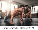 Fitness, coach and male athlete doing push up exercise for strength, health and wellness. Sports, training and man doing bodybuilding workout or challenge with personal trainer for motivation in gym.