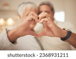 Small photo of Heart hands, emoji and senior couple in home with commitment, support and marriage in retirement together. Love sign, happy man and old woman in apartment with icon for romantic gesture of loyalty.