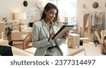 Small photo of Tablet, woman and online stock check with shipping company, logistics and e commerce with tech. Digital inventory checklist, package and supply chain with delivery system and small business owner