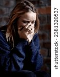 Small photo of Woman, abuse and crying with hands, scared and alone with fear, hiding and afraid. Toxic relationship, shame or home for physical assault, problem or domestic violence with terror, anxiety or pain