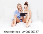 Bedroom, relax and friends with a tablet, smile and funny with humor, blog post and social media. Home, women and girls with technology, connection and happy with internet, comedy and online reading