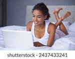 Black woman, laptop and bed as writing on online blog as article, email or digital communication. Happy, female writer or blogger on computer as typing to browse, search or share meme on web network