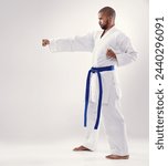Small photo of Studio, karate and African man training technique for physical health of blue belt instructor. White background, male person and adult with disciple of martial arts, sport and fist for combat