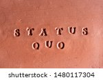 Small photo of the phrase “Status Quo” ( factual situation) written in Latin on a terracotta tablet