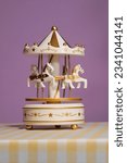 Small photo of merry go round carousel horse toy music box. classic music box. vintage music box. Silver music box mechanism with the handle. Musical toy. old fashioned toys.