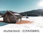 Small photo of Sun is shining on an old barn at Lake Gerold in the German alpes