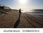A Man Standing On Crosby Beach...