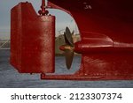 Small photo of ship moored on sleeper At Stern ship Propeller with rudder under Reconstruction, Under the ship, Big ship under Repair on floating dry dock in shipyard