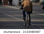  man with bag on bicycle in...