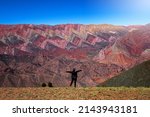 Small photo of Selective Focus. The Hornocal, Jujuy Argentina. Hill of fourteen colors. Happy person in El Hornocal. person posing from behind in El Hornocal. Beautiful landscape of Argentina