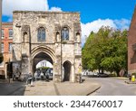 Small photo of Winchester, Hampshire UK - Aug 6 2023: The historic medieval fortified Westgate, which houses a museum, located at the top of the High Street in Winchester, Hampshire, UK. The Westgate was rebuilt i