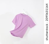 Small photo of Pink tshirt with hanger. Flying cotton T-shirt isolated on white background.