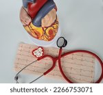 Small photo of Cardiogram with stethoscope and red heart. Treatment of cardiac diseases and hypertension arrhythmia