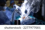 Small photo of Surgical operation robot. Medical operation involving robot. Robotic Surgery. Manipulators performing surgery on humans.
