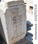 Small photo of Ephesus, Turkey - 07 15 2012: A white marble stone with symbol of Aesculapius, summertime, sunny day