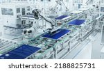 Small photo of Wide Shot of Solar Panel Production Line with Robot Arms at Modern Bright Factory. Solar Panels are being Assembled on Conveyor.