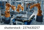 Small photo of Advanced Orange Industrial Robot Arms Assemble EV Battery Pack on Automated Production Line. Row of Robotic Arms inside Automotive Plant Assemble Batteries. Modern Electric Car Smart Factory.