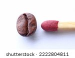 A match next to a roasted coffee bean