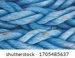 Nautical background. Old blue frayed ship rope closeup. Classic blue texture.