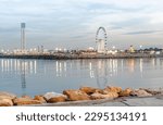 Small photo of Algiers great mosque world biggest minaret, ferris wheel and pirate ship in Sablette promenade amusement park, jetty rocks and lights reflexion illuminated in water, blue cloudy sky at dusk sunset.