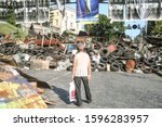 Small photo of KIEV, UKRAINE - AUGUST 5, 2014: Man standing near a Euromaidan barricade on Heroyiv Nebesnoyi Sotni during the revolution & protests on Maidan Square, on a Memorial erected to people killed by snipers