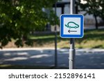 Small photo of Selective blur on a road sign indicating an electric car charging station used to fill with electricity electrical vehicles, abiding by European laws on traffic signalization.