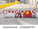Selective blur on road barriers and no traffic signs, European standard, in front of a road being blocked for road repair and reconstruction in an urban environment.