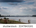 Panorama of the sava river in Sabac, serbia, with a focus on the Zeleznicki most, a steel railway bridge, in front of the city beach. Sabac is a Serbian city in the macva region.