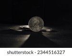 Small photo of Selective blur on two denar coin with mention 2 Denari meaning in Macedonian 2 denars, isolated on black background around other coins. MKD, Macedonian Denar, is currency money of Northern Macedonia