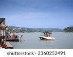 Small photo of BELGRADE, SERBIA - JULY 31, 2021: Panorama of young people, male and female, swimming and relaxing on a splav, a serbian raft, on Reka Sava River in Obrenovac, belgrade, by a Motorboat speedboat.