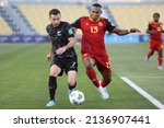 Small photo of Doha, Qatar - March 18 2022: Kosta Barbarouses of New Zealand and Tommy Semmy of Papua New Guinea tussle for the ball during their OFC 2022 World Cup Qualifier Group B match.