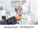 Small photo of Close up hands of Handsome asian male selling pharmacist and female customer buying medicine in the pharmacy drugstore, hand over capsule pills of medicine from hand to another hand charge.
