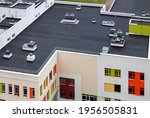 Top view dark flat roof with air conditioners and hydro insulation membranes modern apartment building residential area.