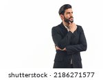 Small photo of Hispanic businessman with dark slick hair and beard wearing suit looking into the distance with hand on chin thinking and focused. Studio shot. Isolated. High quality photo