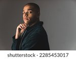 Small photo of Young African American man with buzz cut on a grey dark studio background . High quality photo