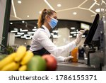 Small photo of People endangered on their workplace because of corona virus. Cashier with protective hygienic mask and gloves working in supermarket and fighting against COVID-19 or corona virus pandemic.