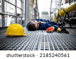 Small photo of Blue collar worker lying down unconscious due to his injury at work and dizziness.