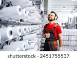 Textile factory worker standing ...