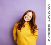 Young redhead woman laughing at camera